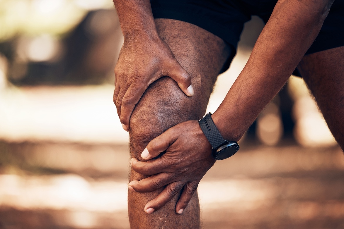 Man holding knee in pain