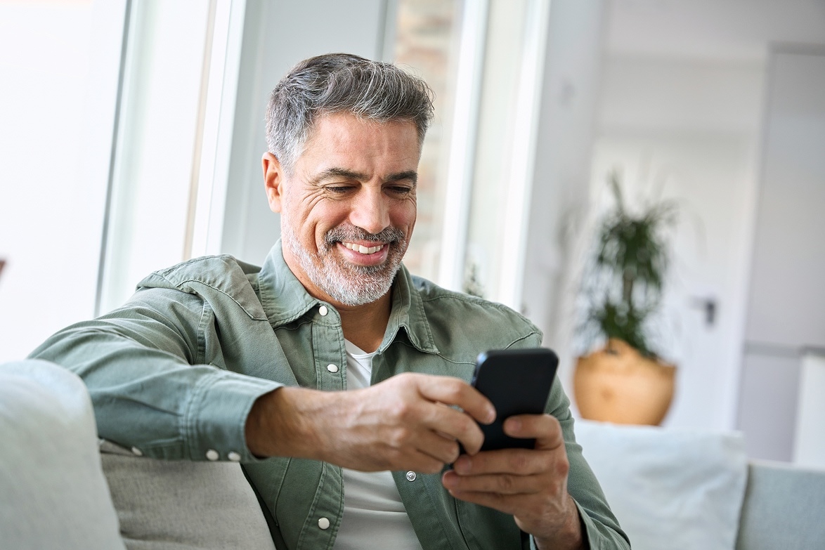 Man using mobile device on sofa